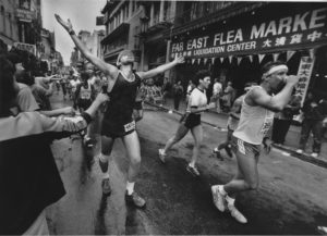 Black and white image of SFM runners in the rain