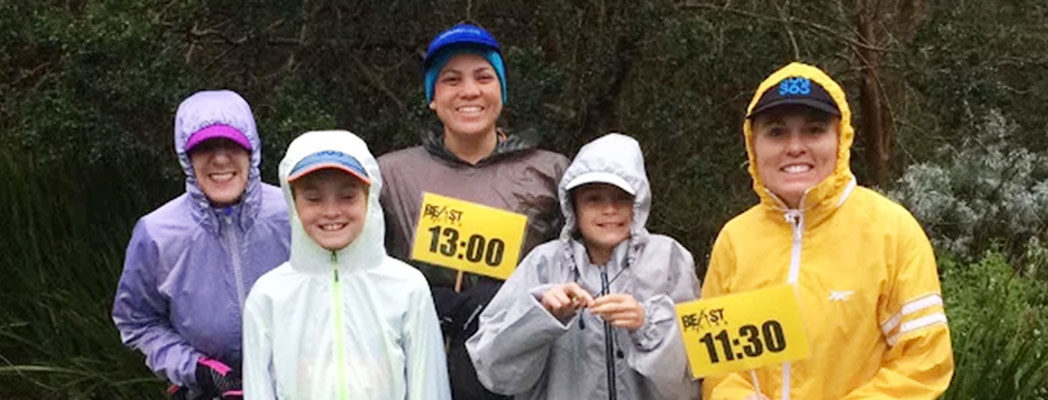 The author with her kids prepared for a run in the rain, raising runners