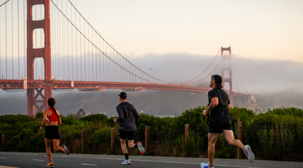 Three runners on the background of the Golden Gate Bridge during their SFM destination race