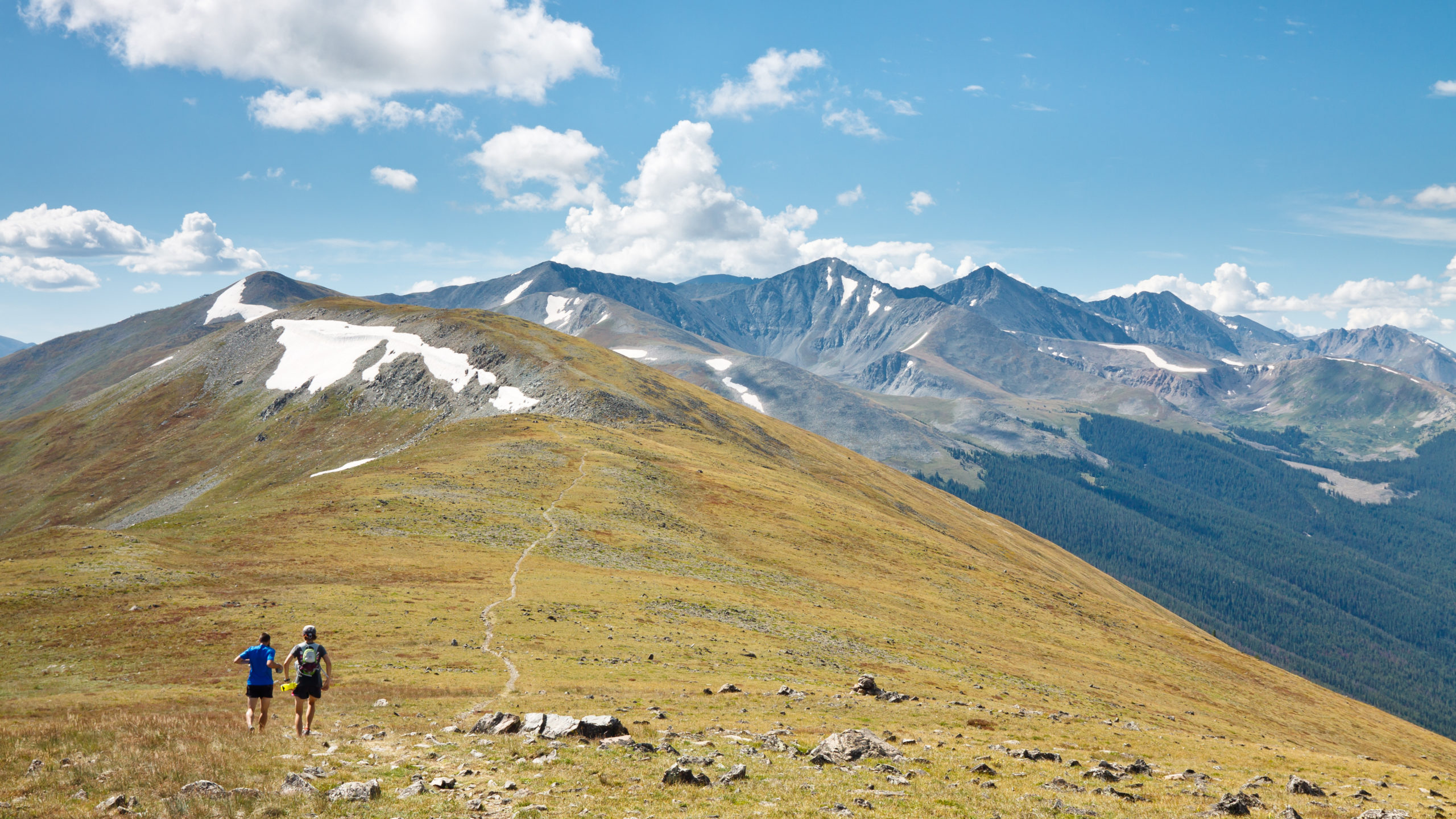 Two runners run trails in the Rocky Mountains in Colorado