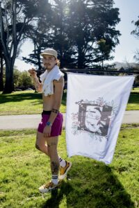 Cal Calamia holds the Non-Binary Run Club flag