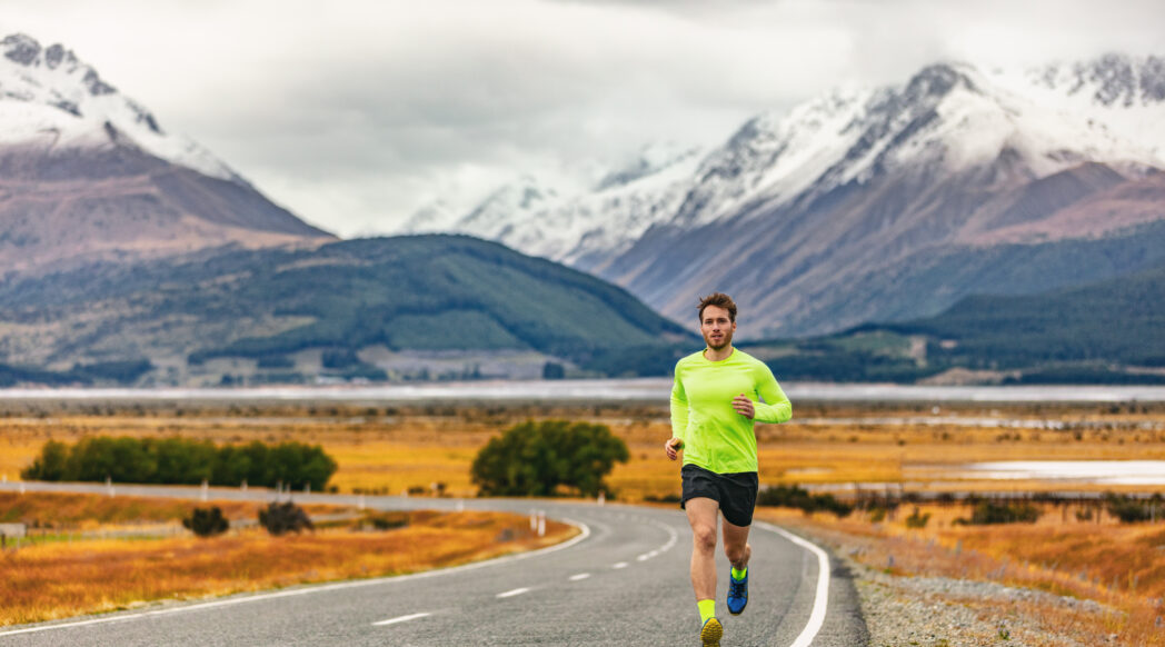 A runner is completing their long run with mountains in the background