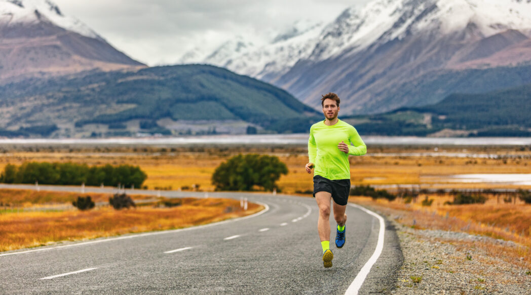 A runner is completing the long run with mountains in the background
