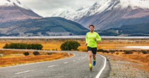 A runner is completing the long run with mountains in the background