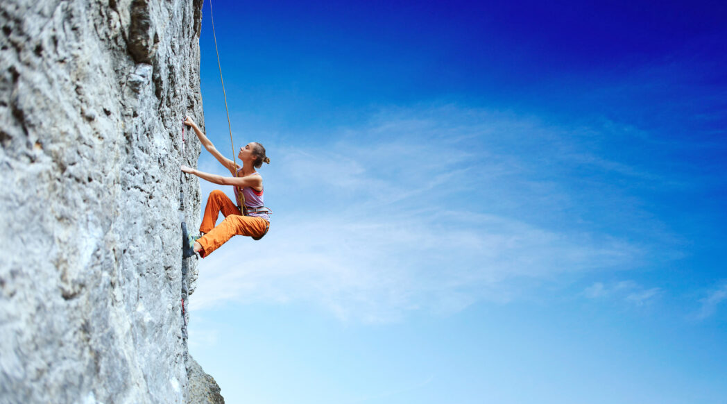 A woman climbs a mountain—how to implement other activities into marathon training