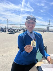 Lucie Nestrasilova poses with her San Francisco Marathon medal