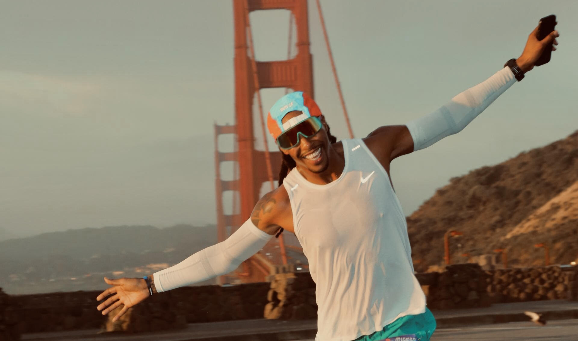 Sanyika Shakur, this Runner Spotlight athlete, runs with the Golden Gate Bridge in the background.