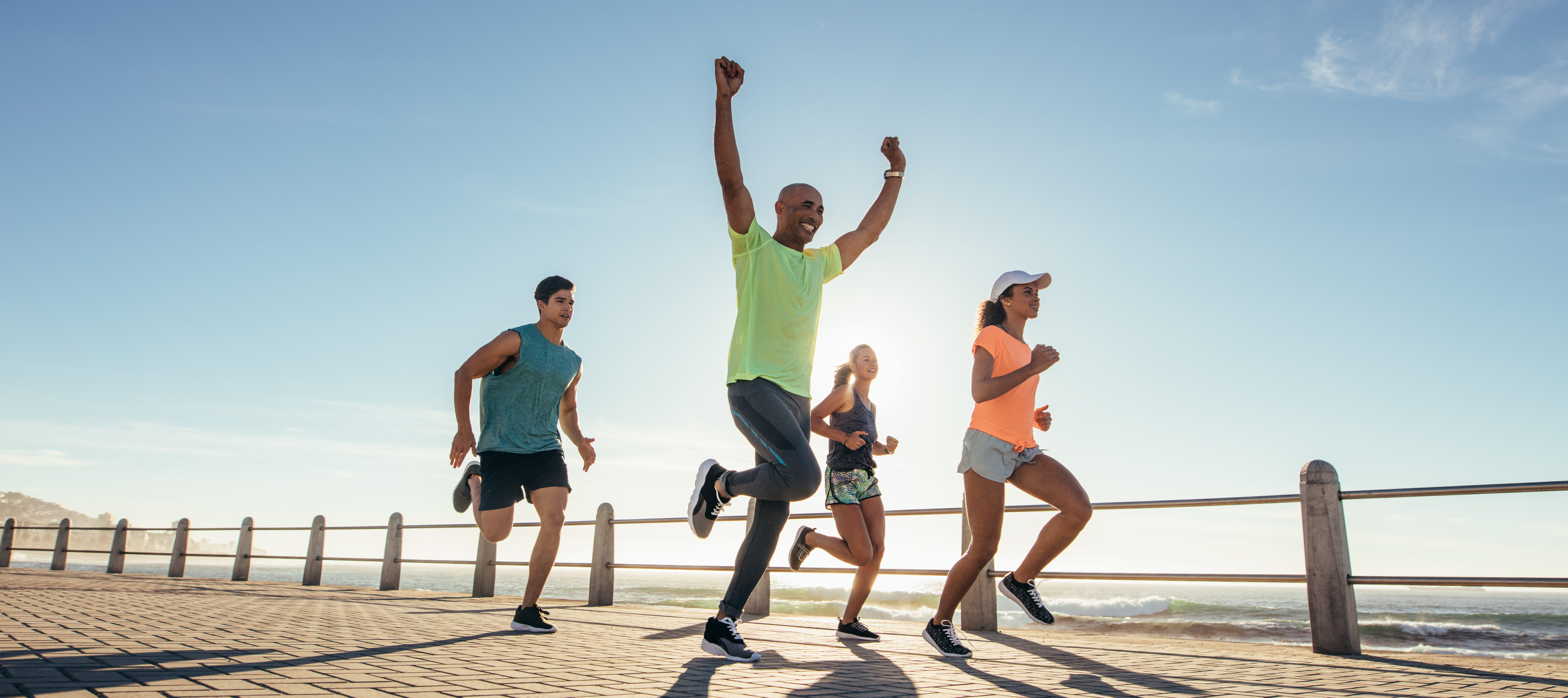 A group of runners from the running community run together on a sunny day