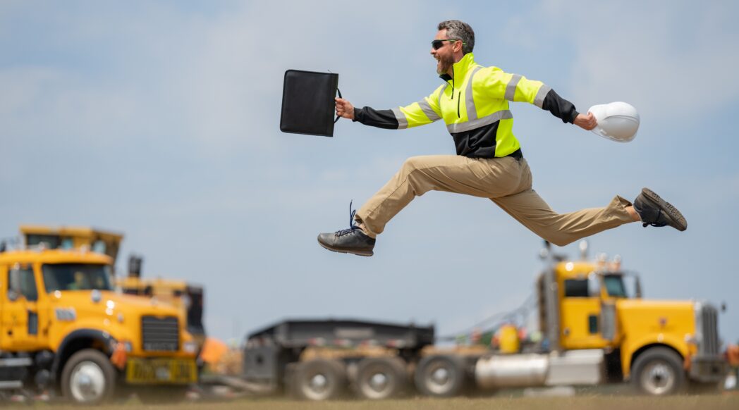 A construction worker happily skips, training with a physical job