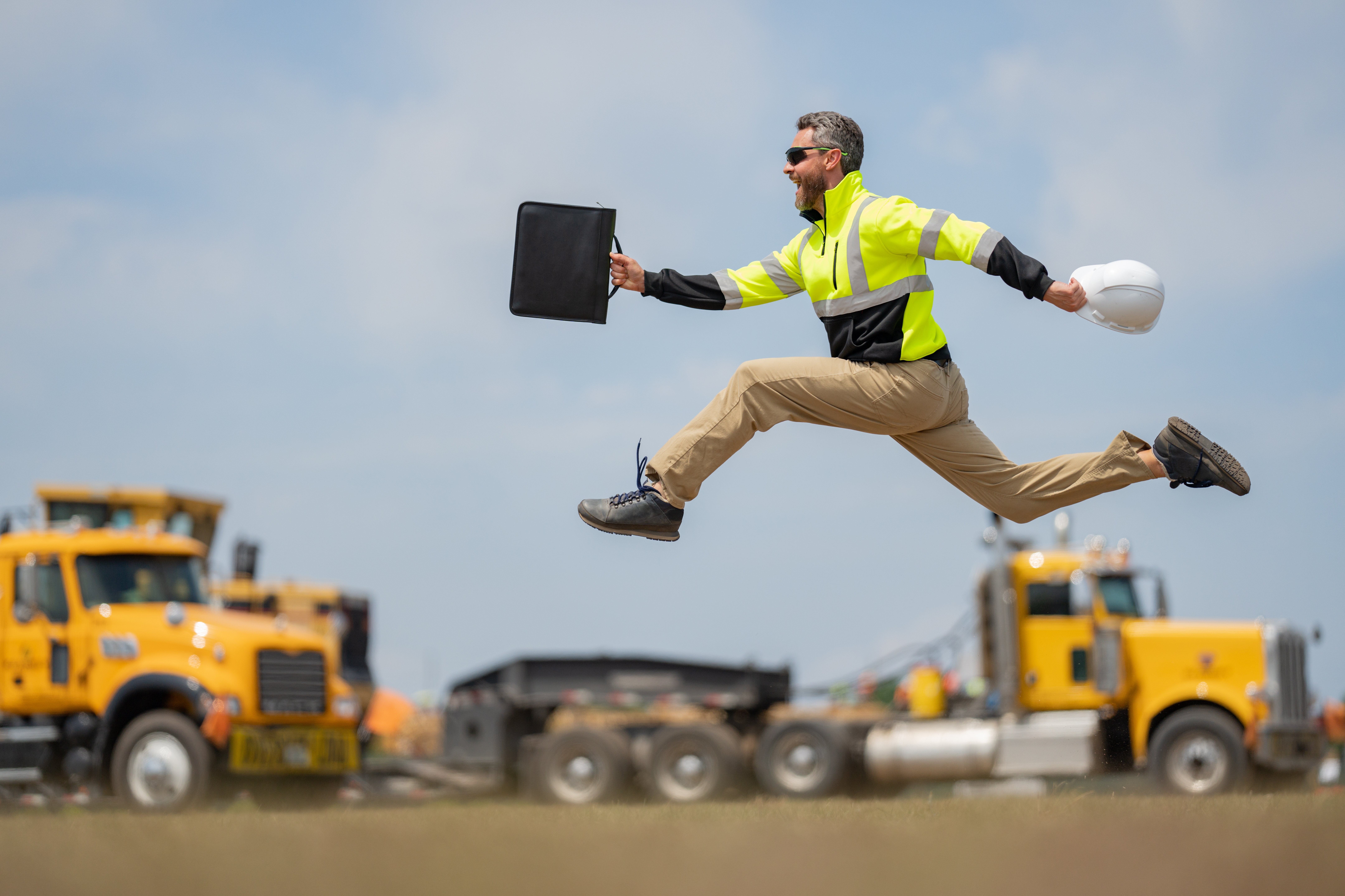 A construction worker happily skips, training with a physical job