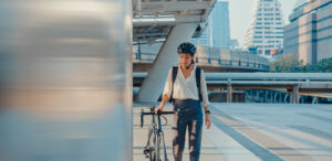A young professional Asian woman commutes to work by bike
