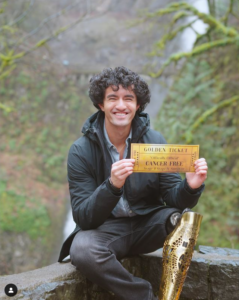 Alex Parra poses with a "cancer free" golden ticket