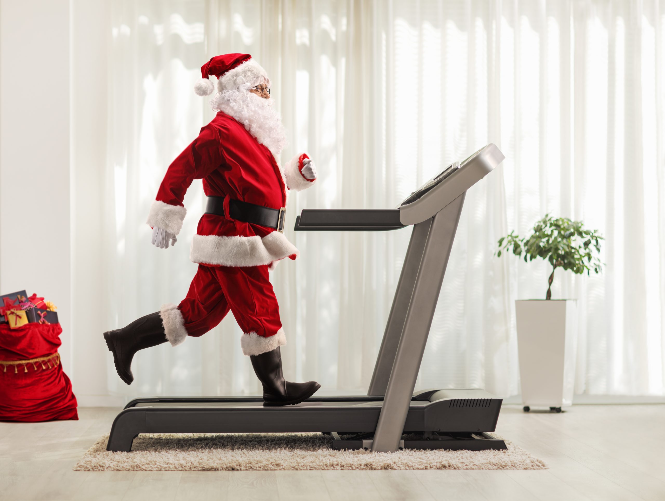 A Santa is running on a treadmill during Christmas. Goals.