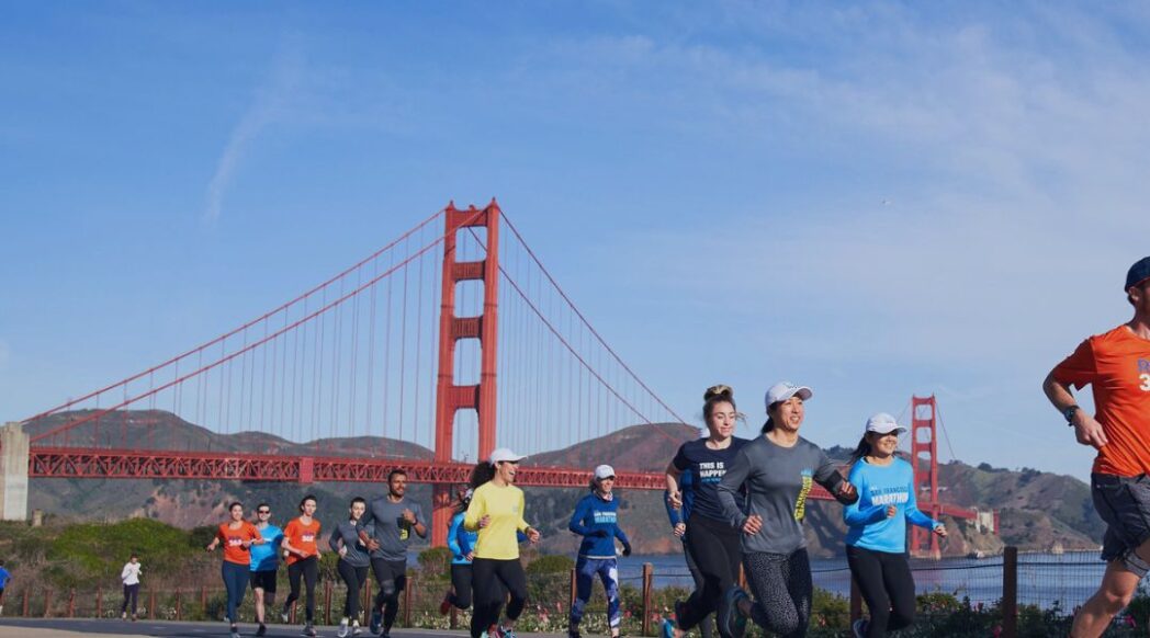 RUN365 runners are running with the Golden Gate Bridge and Marin Headlands in the background