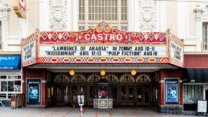 The front of the Castro neighborhood theatre with the front advertising "Lawrence of Arabia," "Midsommar," and "Pulp Fiction