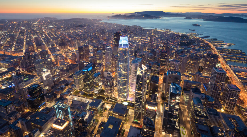 An aerial view of the dominant Salesforce Tower in San Francisco at night
