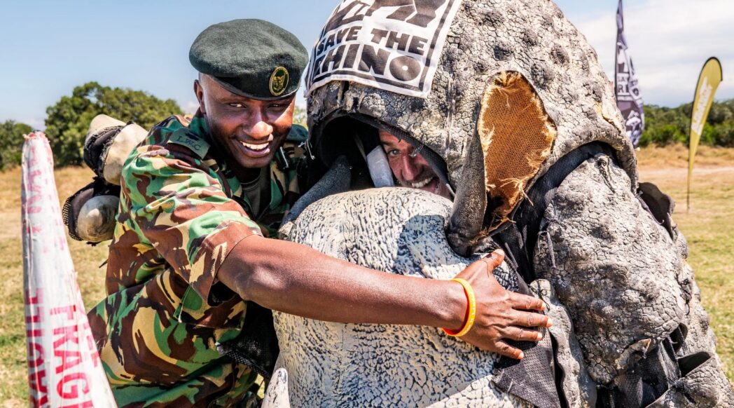 Edward Ndiritu with RhinoBoy Chris in a rhino costume by Save the Rhino