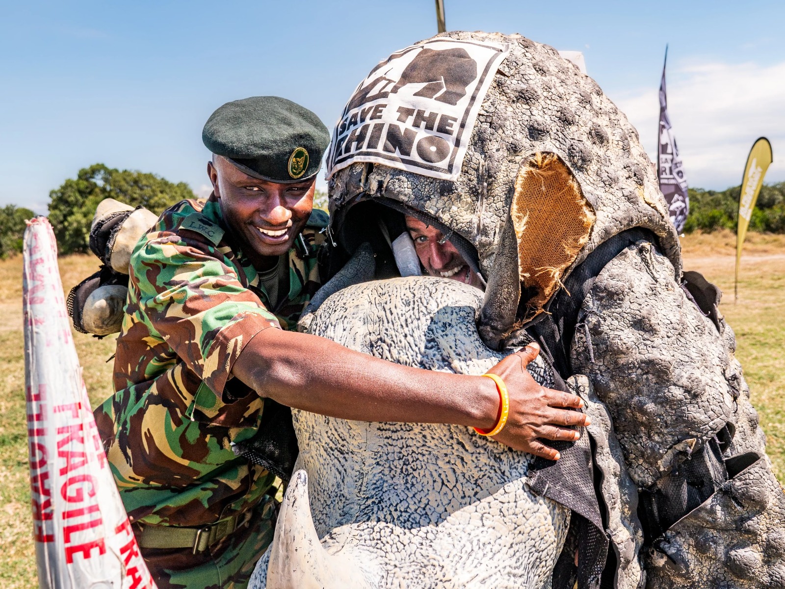 Edward Ndiritu with RhinoBoy Chris in a rhino costume by Save the Rhino