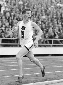 Taisto Mäki has just finished his 10,000 meter and set the new world record. Looking over his shoulder as he runs.