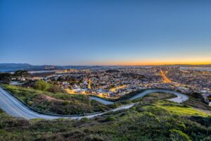 A view of San Francisco from the top of Twin Peaks, evening, city is lit up
